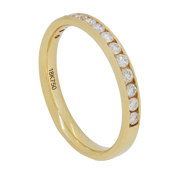 A modern, 18ct yellow gold. diamond set half eternity ring