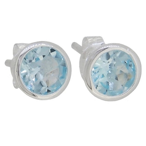 A pair of modern, silver, blue topaz set stud earring