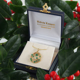 A modern, 9ct yellow gold, emerald set pendant.