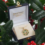 A modern, 9ct yellow gold, emerald set pendant.