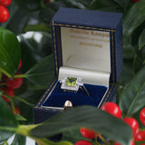 A modern, platinum, peridot & diamond set, square, Art Deco style cluster ring.