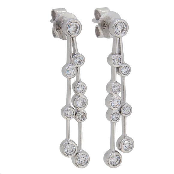 A pair of modern, 18ct white gold, diamond set drop earrings