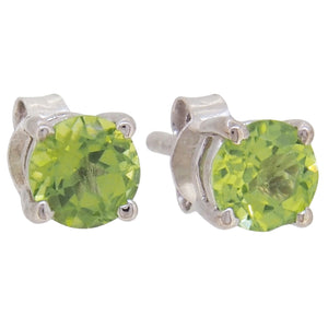 A pair of modern, silver, peridot set stud earrings