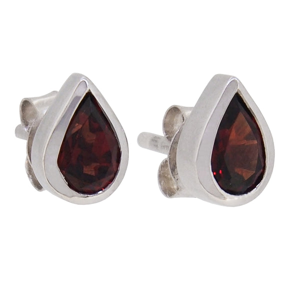 A pair of modern, silver, garnet set stud earrings