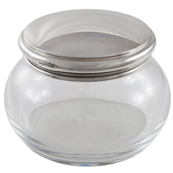 A modern, glass jar with a silver lid