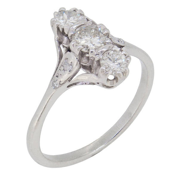 A mid-20th century, 18ct white gold, diamond set, 'up finger' style, three stone ring