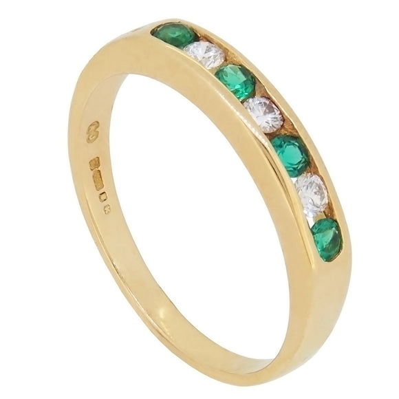 A modern, 18ct yellow gold, emerald & diamond set, seven stone, half eternity ring