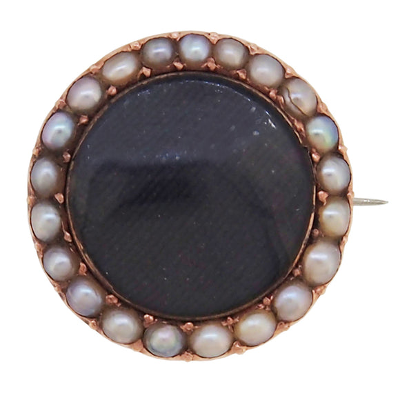 A Victorian, yellow gold, pearl set, circular mourning brooch