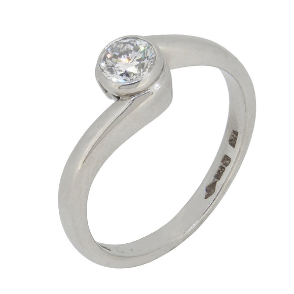 A modern, platinum, diamond set, single stone, solitaire crossover ring