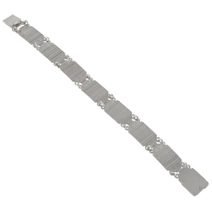 A modern, silver, seven panel bracelet