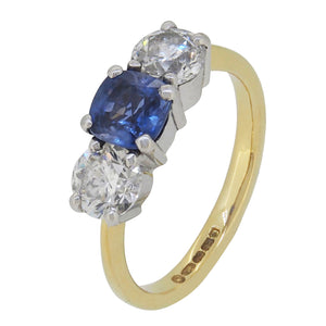 A modern, 18ct yellow gold, sapphire & diamond set three stone ring