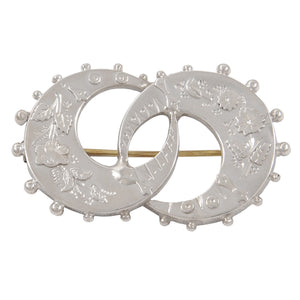 A Victorian, silver, double crescent brooch with floral decoration