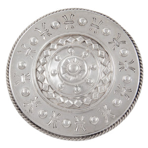 A silver, domed circular brooch