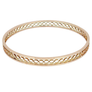 An early 20th century, 9ct yellow gold, pierced bangle