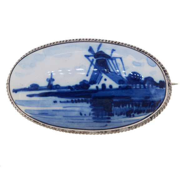 A mid-20th century, silver, Delft set brooch, featuring an image of a windmill.