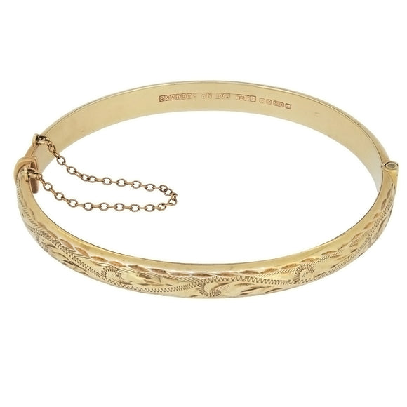 A modern, 9ct yellow gold, half engraved, hollow, hinged bangle