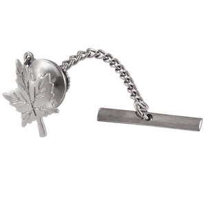 A modern, silver, maple leaf tie tack with a white metal fitting.