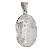 A modern, silver, engraved oval locket