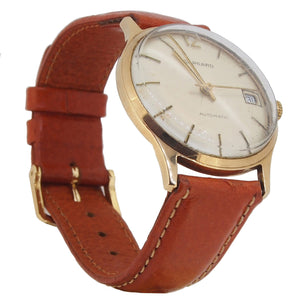 A modern, 9ct yellow gold, Garrard wrist watch with a brown leather strap