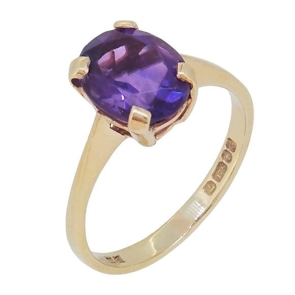 A modern, 9ct yellow gold, amethyst set, single stone ring