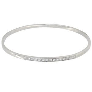 A modern, 18ct white gold, diamond set bangle