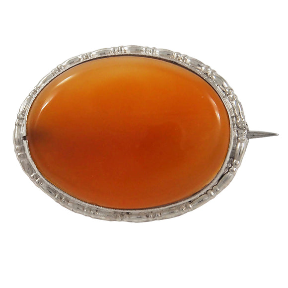 An early 20th century, silver, brown agate set oval brooch
