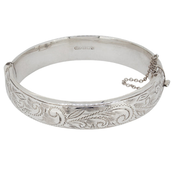 A mid-20th century, silver, half engraved, hollow, hinged bangle