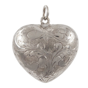 A modern, silver, fully engraved, heart shaped pendant