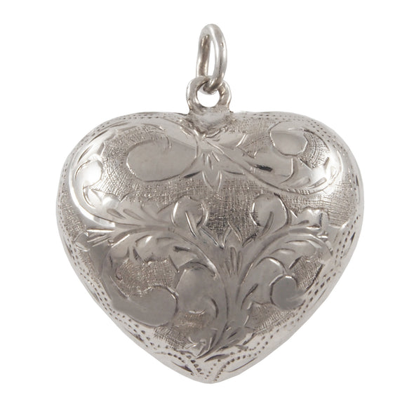 A modern, silver, fully engraved, heart shaped pendant