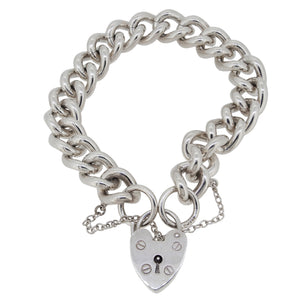 A modern, silver, curb link bracelet with a padlock clasp