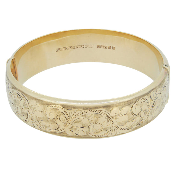 A modern, 9ct yellow gold, fully engraved, hollow, hinged bangle