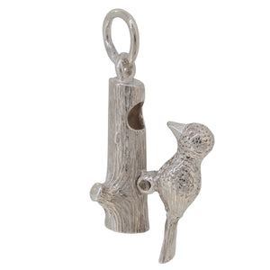 A silver, woodpecker charm pendant