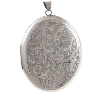 A modern, silver, engraved oval locket