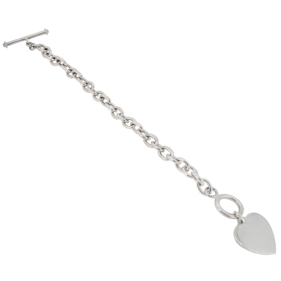 A modern, silver, heavy trace oval link bracelet with a toggle fastener & heart charm