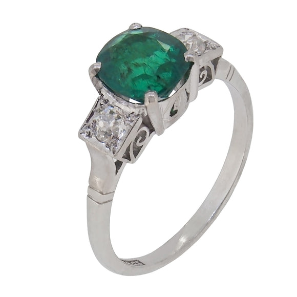 A mid-20th century, 18ct white gold & platinum setting, emerald & diamond set three stone ring