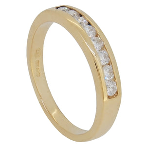 A modern, 18ct yellow gold, diamond set, eight stone, channel set half eternity ring.