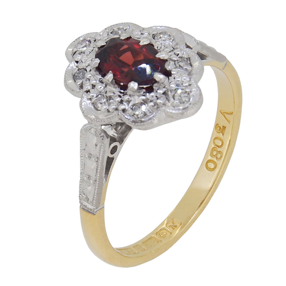 A mid-20th century, 18ct yellow & white gold, garnet & diamond set oval cluster ring