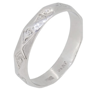 A modern, platinum, faceted wedding ring