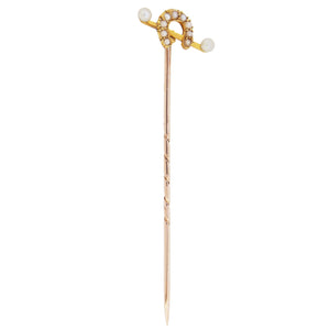 An early 20th century, yellow gold, pearl set horseshoe stick pin