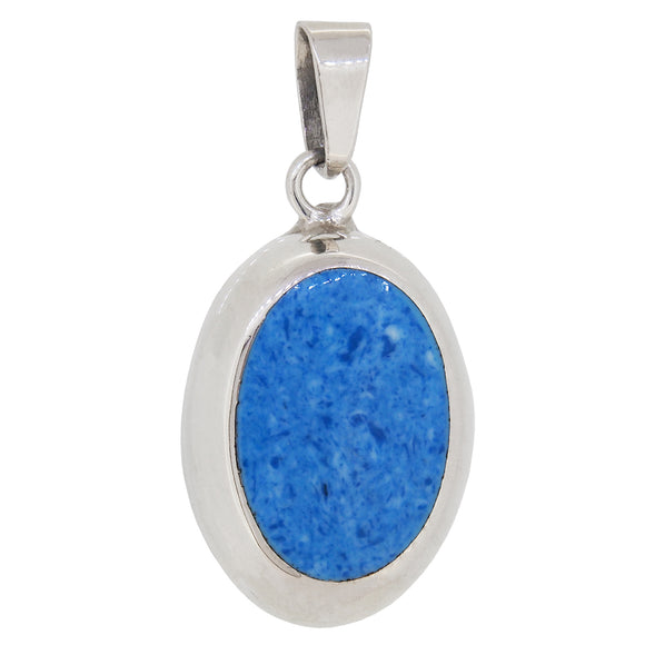 A modern, silver, blue glass set oval pendant