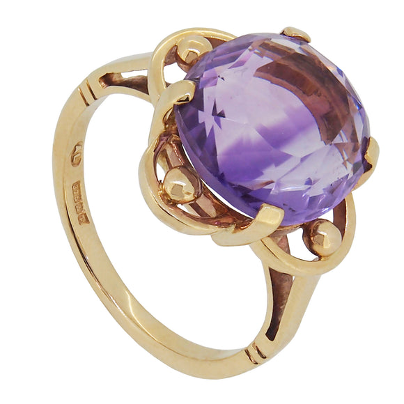 A modern, 9ct yellow gold, amethyst set, single stone ring