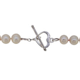 A modern, single row of cultured freshwater pearls on a silver toggle