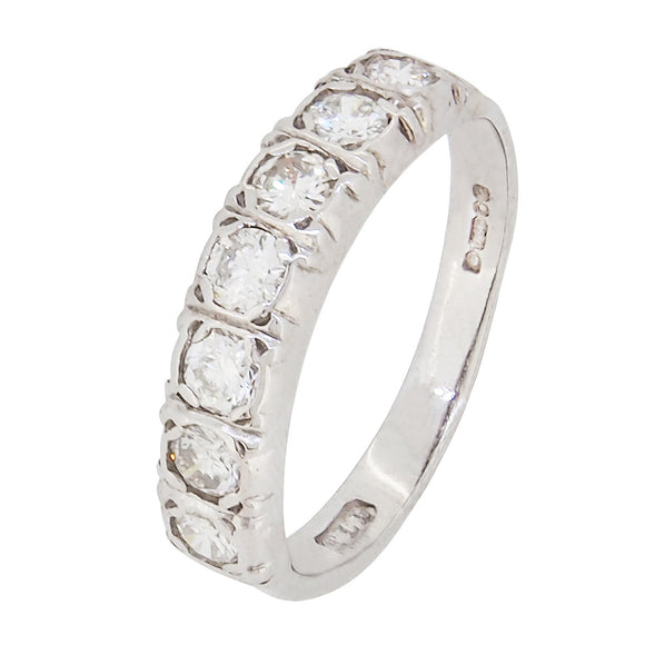 A modern, 18ct white gold, diamond set, seven stone half eternity ring