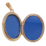 A modern, 9ct yellow gold, half engraved oval locket open
