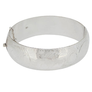 A modern, silver, hollow, fully engraved hinged bangle