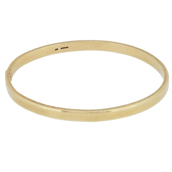 A modern, 9ct yellow gold, solid bangle with a bark finish