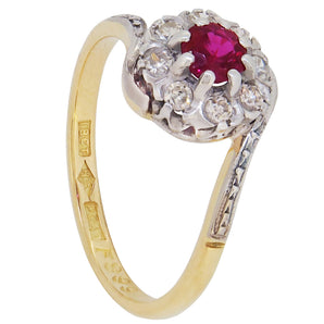 A mid-20th century, yellow metal, ruby & diamond set cluster crossover ring.