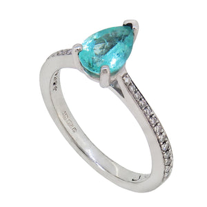 A modern, platinum, paraiba tourmaline set ring with diamond set shoulders