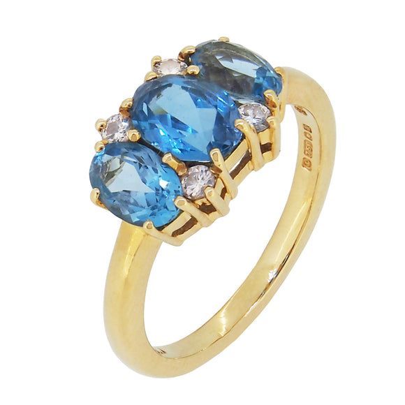 A modern, 18ct yellow gold, blue topaz & diamond set seven stone ring