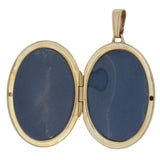 A modern, 9ct yellow gold, engraved oval locket open